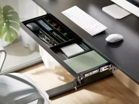 Open view of large metal drawer showing internal organizer tray for pens and open space for tablets.