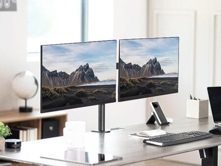 Ergonomic desk setup showing two monitors mounted on the Furnotix dual arm for a clean, minimal look.