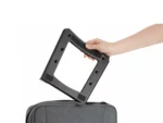 Foldable laptop riser being placed into a bag, showing portable design.