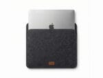 Furnotix grey felt laptop sleeve with MacBook inserted, showing snug fit.