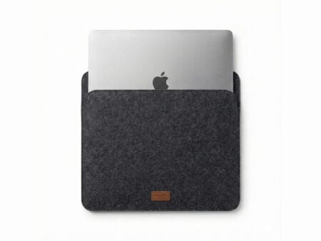Furnotix grey felt laptop sleeve with MacBook inserted, showing snug fit.