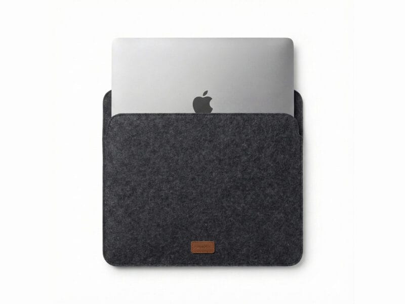 Furnotix grey felt laptop sleeve with MacBook inserted, showing snug fit.