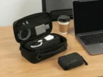 Furnotix Tech pouch open view besides a laptop and a coffee on a table