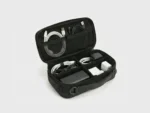 Inside view of electronics organizer bag showing cables, charger, and power bank storage.