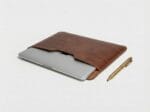 MacBook Pro 15 inch inside a slim leather laptop pouch by Furnotix.