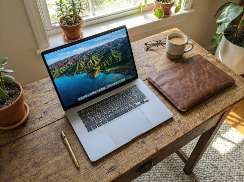 Minimalist leather laptop case protecting a silver MacBook.