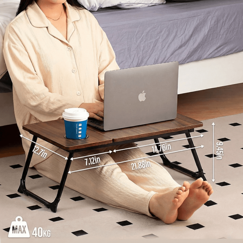 Woman using portable bed table for writing, laptop work, and eating breakfast.